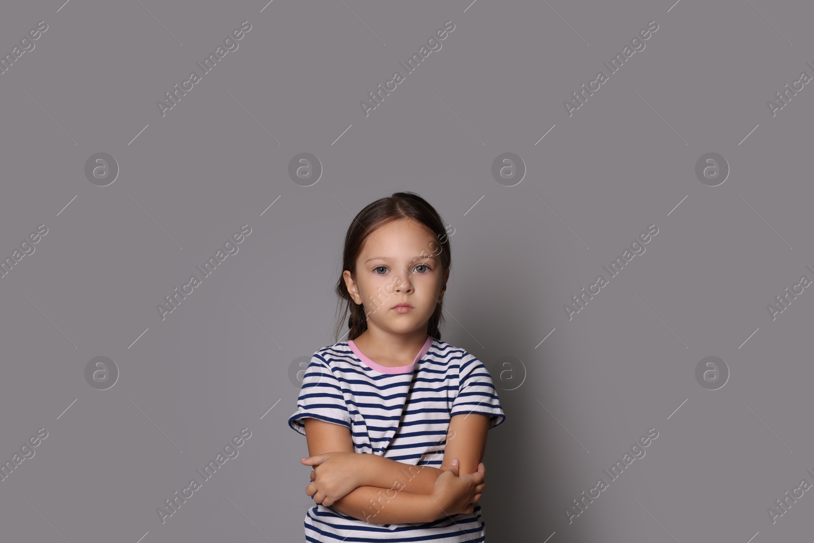 Photo of Orphanage concept. Sad girl on gray background