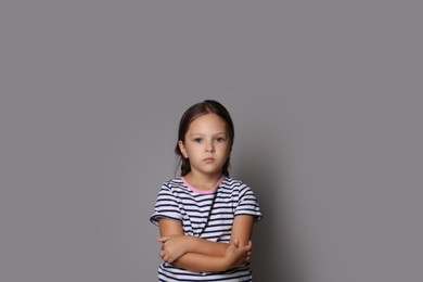 Photo of Orphanage concept. Sad girl on gray background