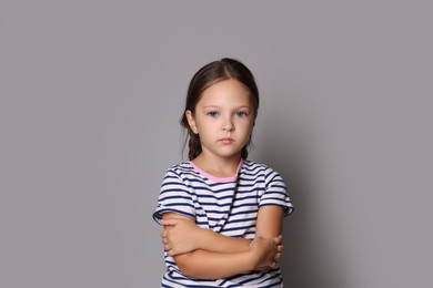 Photo of Orphanage concept. Sad girl on gray background