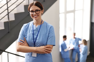 Smiling healthcare worker with badge in hospital