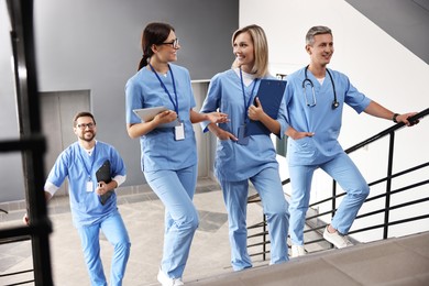 Photo of Healthcare workers walking up stairs in hospital