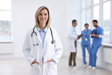 Photo of Healthcare workers in hospital, selective focus. Portrait of smiling nurse indoors