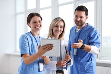 Group of healthcare workers with tablet in hospital