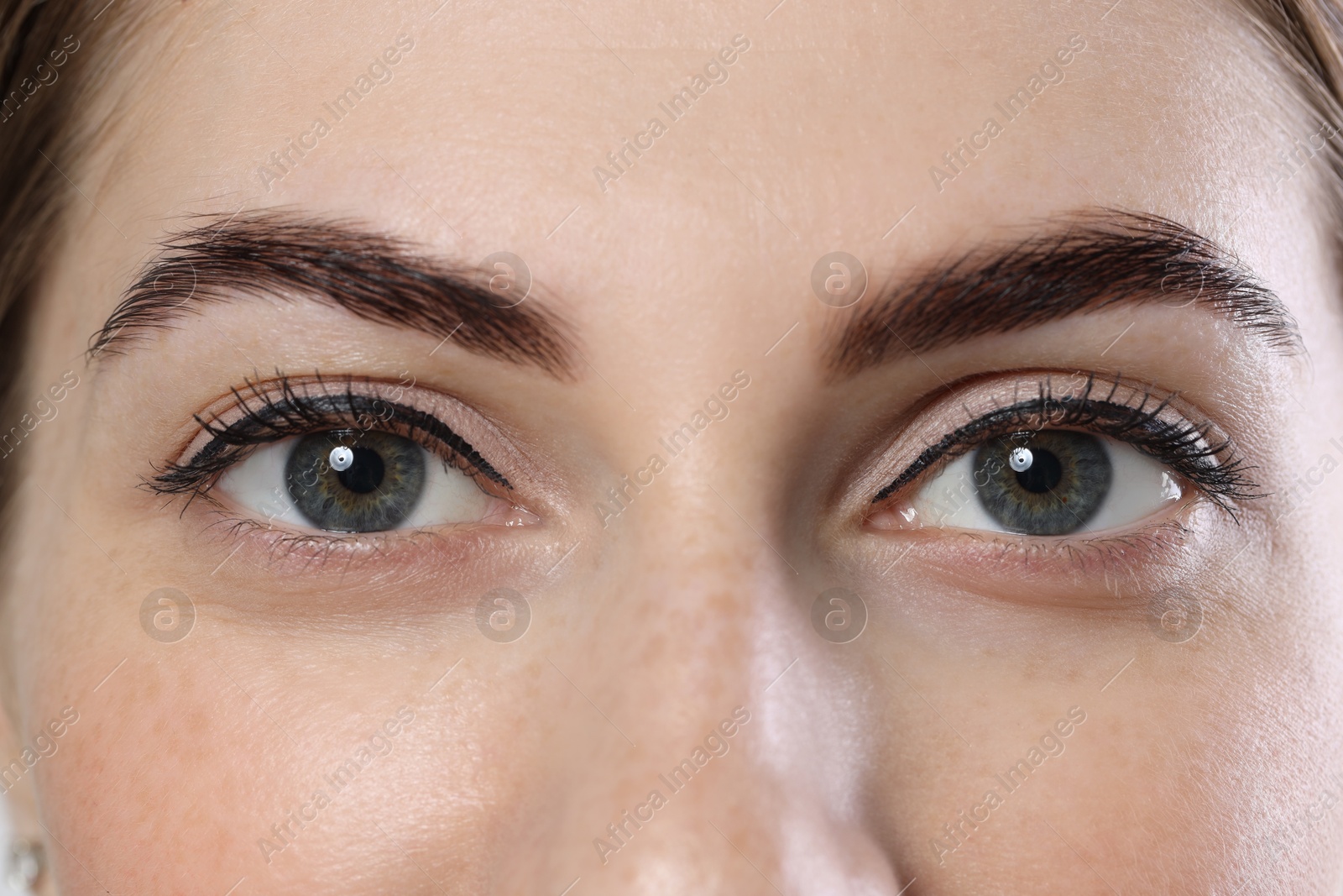 Photo of Beautiful young woman after henna eyebrows dyeing, closeup