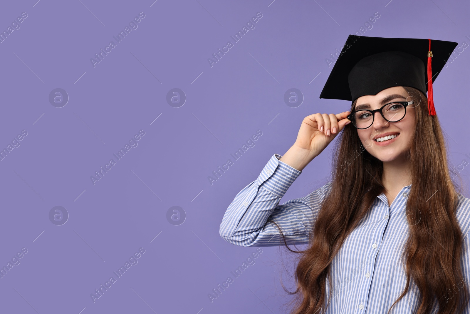 Photo of Happy student after graduation on violet background. Space for text