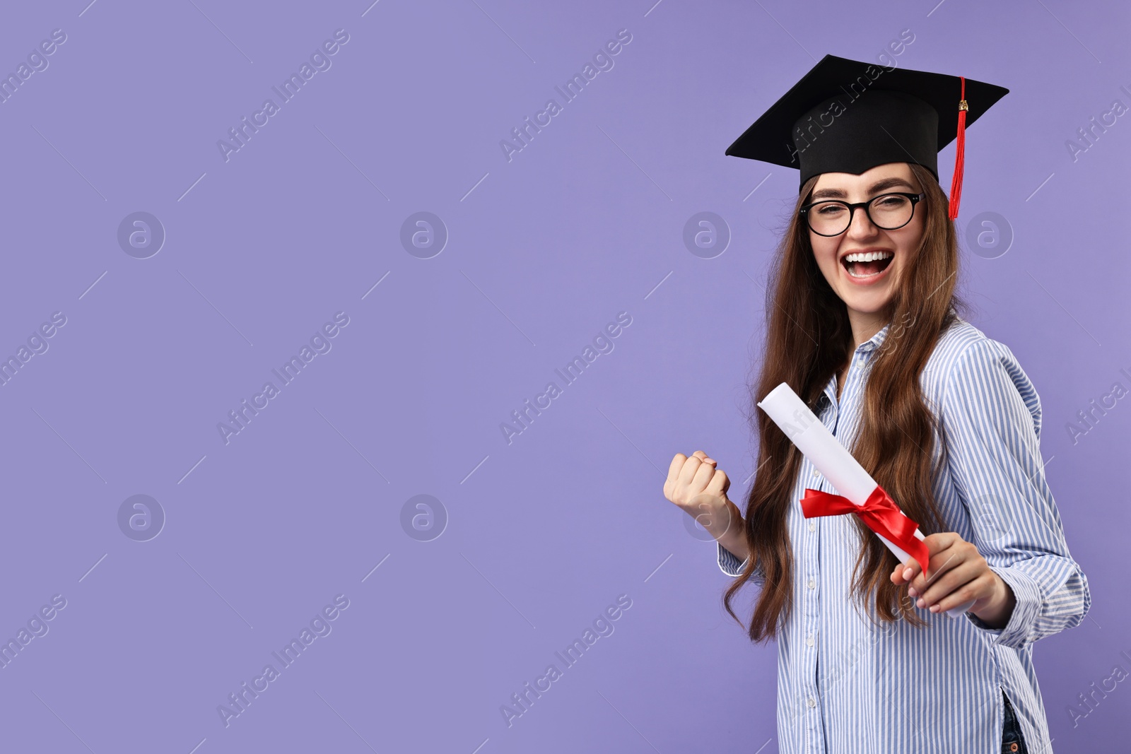 Photo of Happy student with diploma after graduation on violet background. Space for text