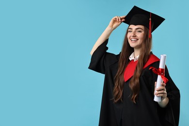 Photo of Happy student with diploma after graduation on light blue background. Space for text