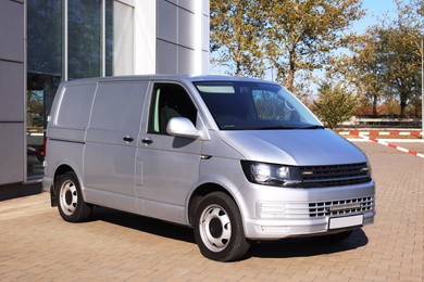 Photo of One gray minibus outdoors on sunny day