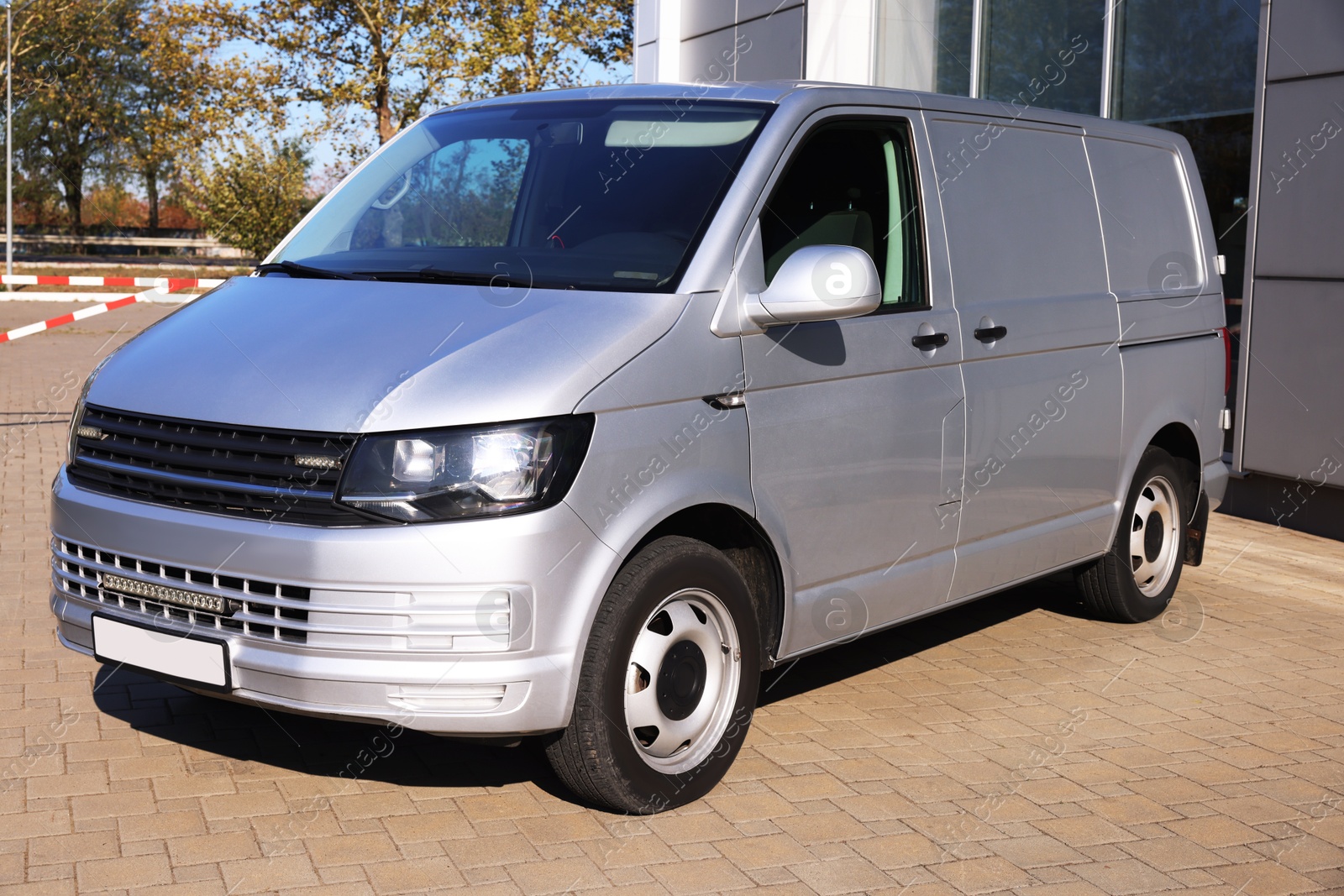 Photo of One gray minibus outdoors on sunny day