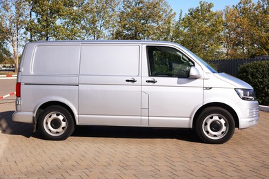 Photo of One gray minibus outdoors on sunny day