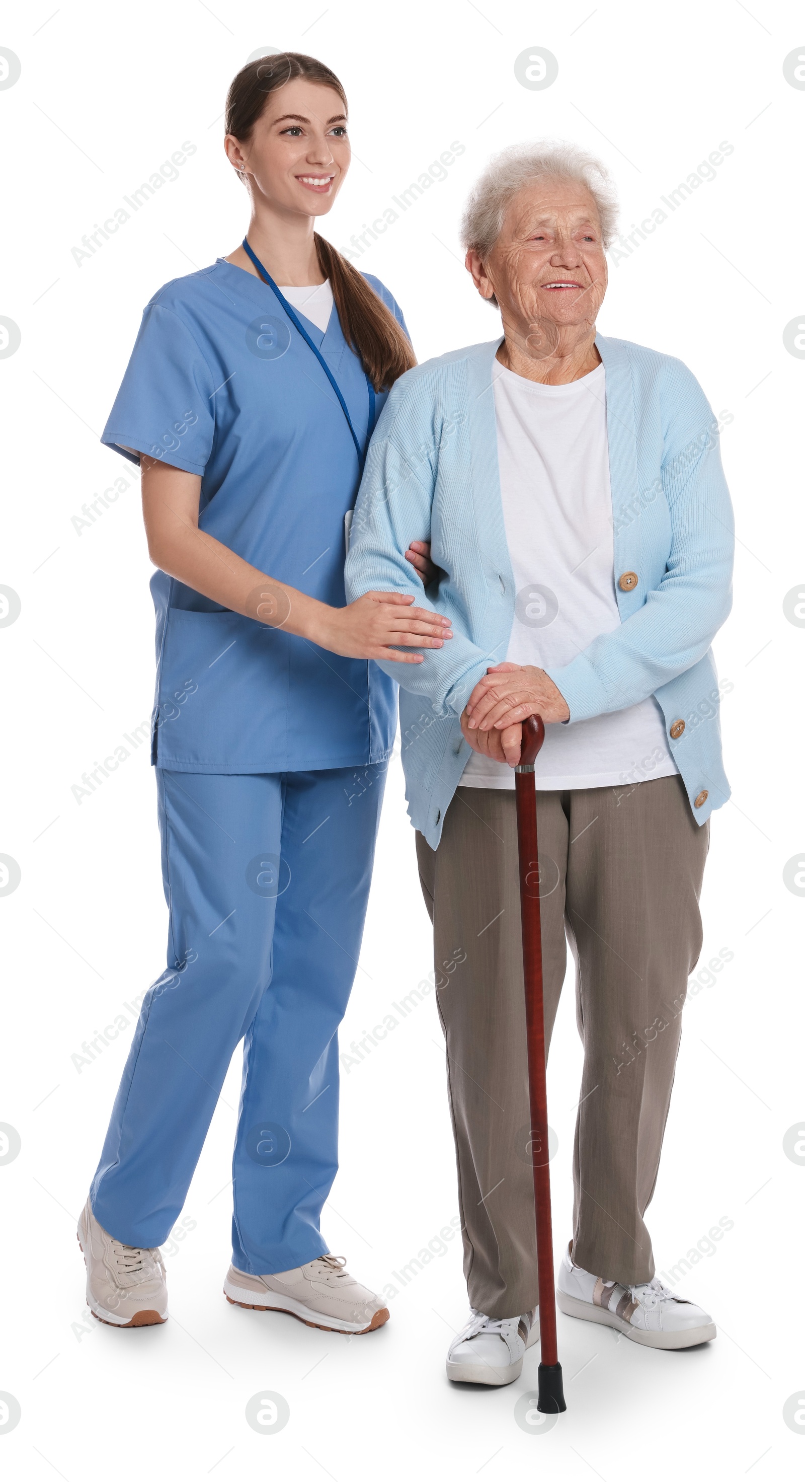 Photo of Caregiver supporting senior woman with walking cane on white background. Home health care service