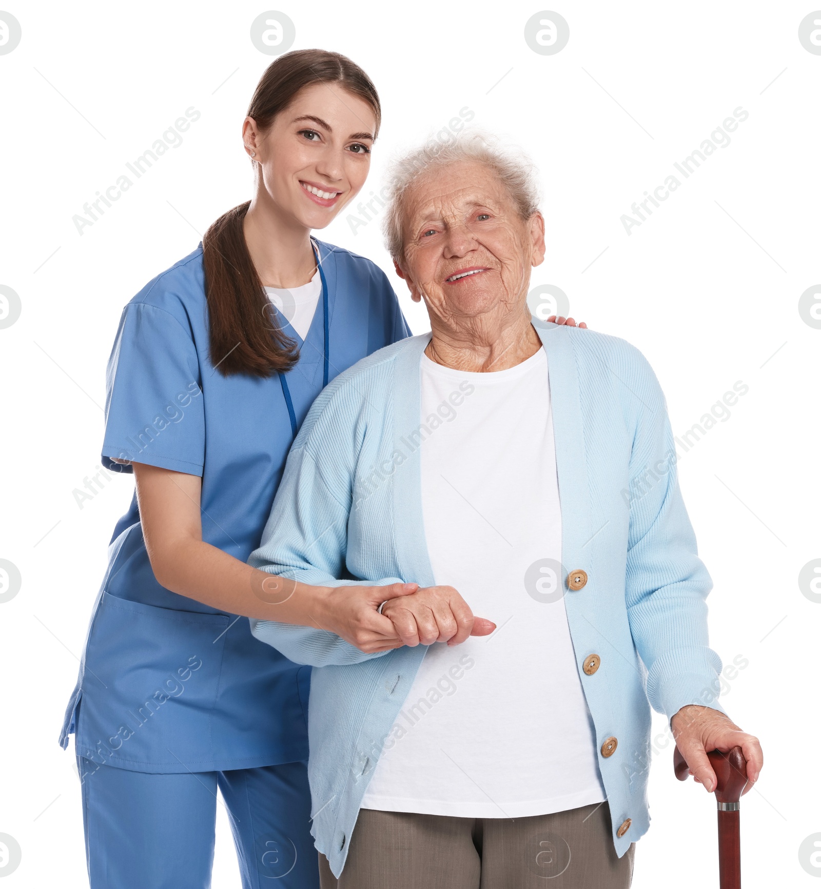 Photo of Caregiver supporting senior woman with walking cane on white background. Home health care service