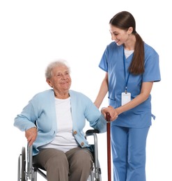 Caregiver assisting senior woman in wheelchair on white background. Home health care service