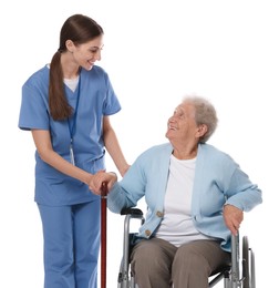 Caregiver assisting senior woman in wheelchair on white background. Home health care service