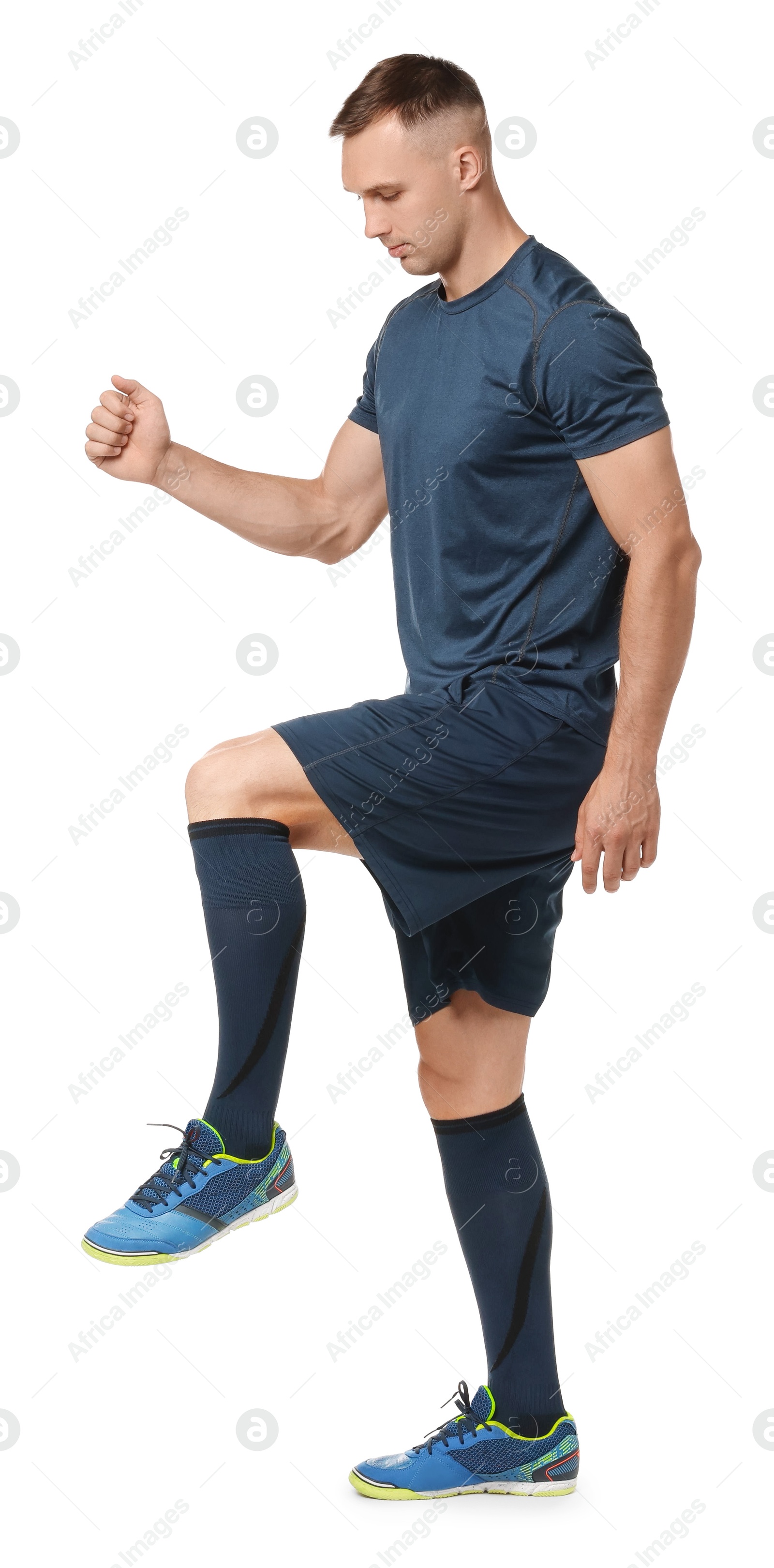 Photo of Football player in sportswear training on white background