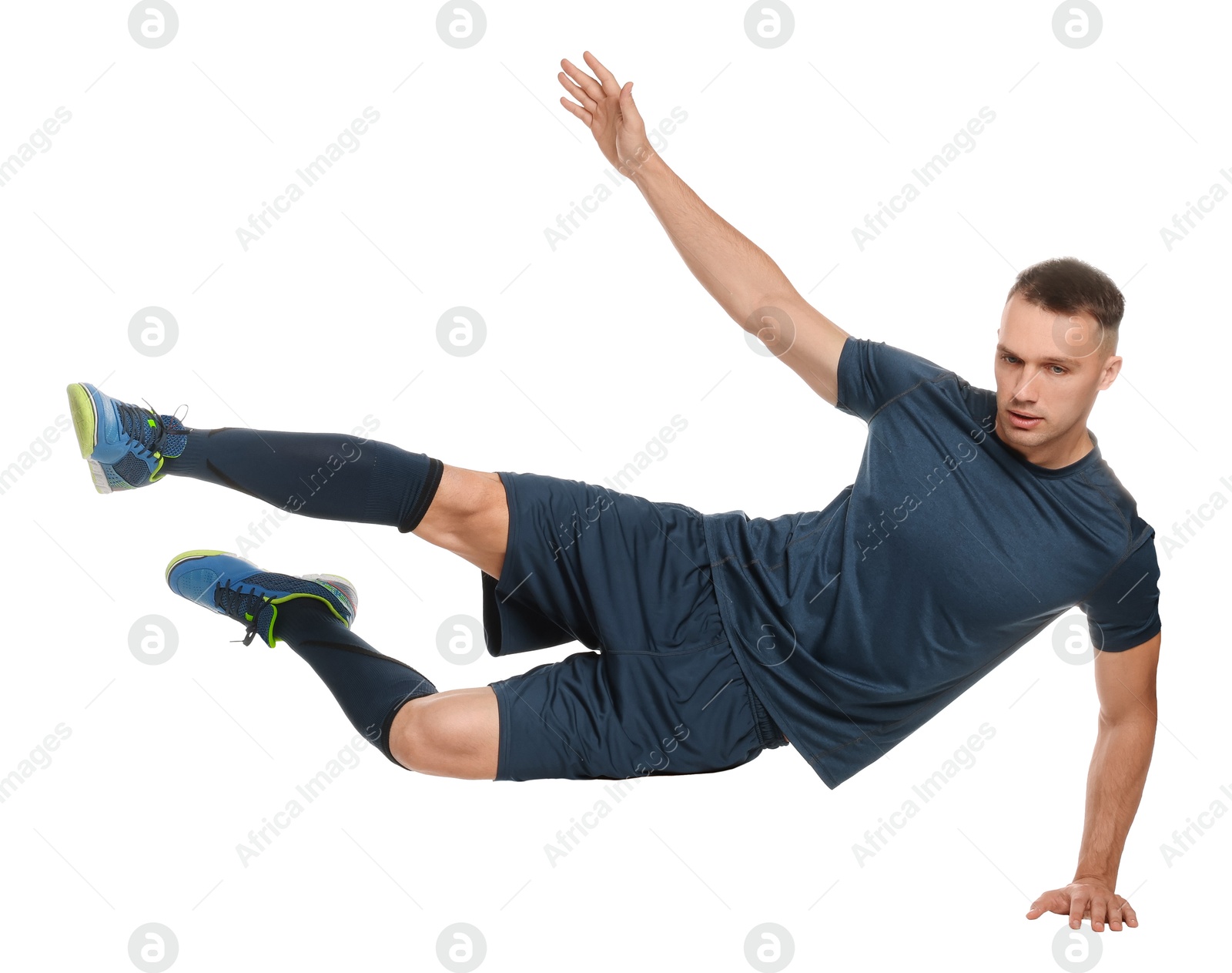 Photo of Football player in sportswear training on white background