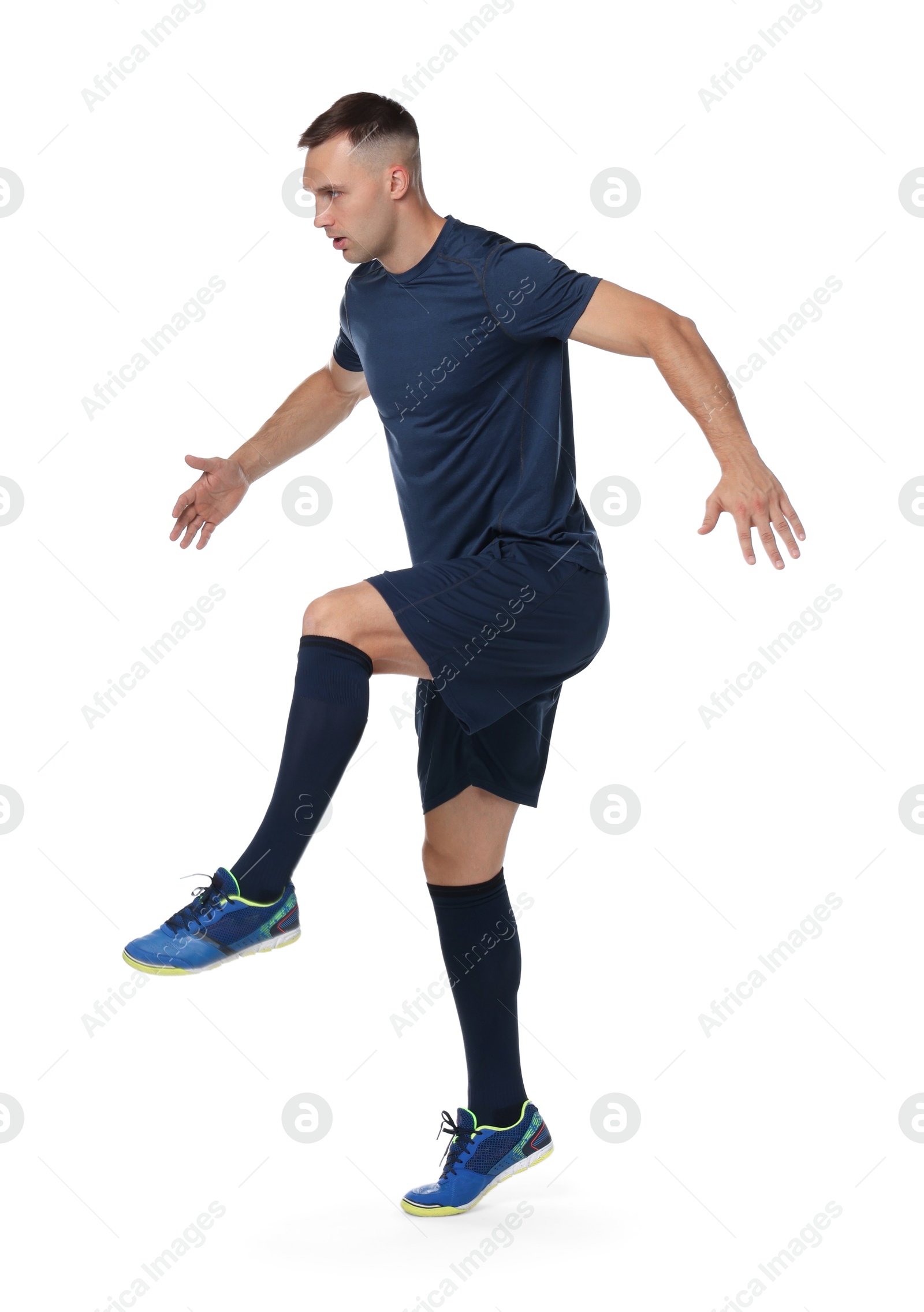 Photo of Football player in sportswear training on white background