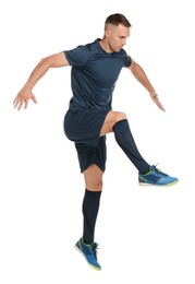 Photo of Football player in sportswear training on white background