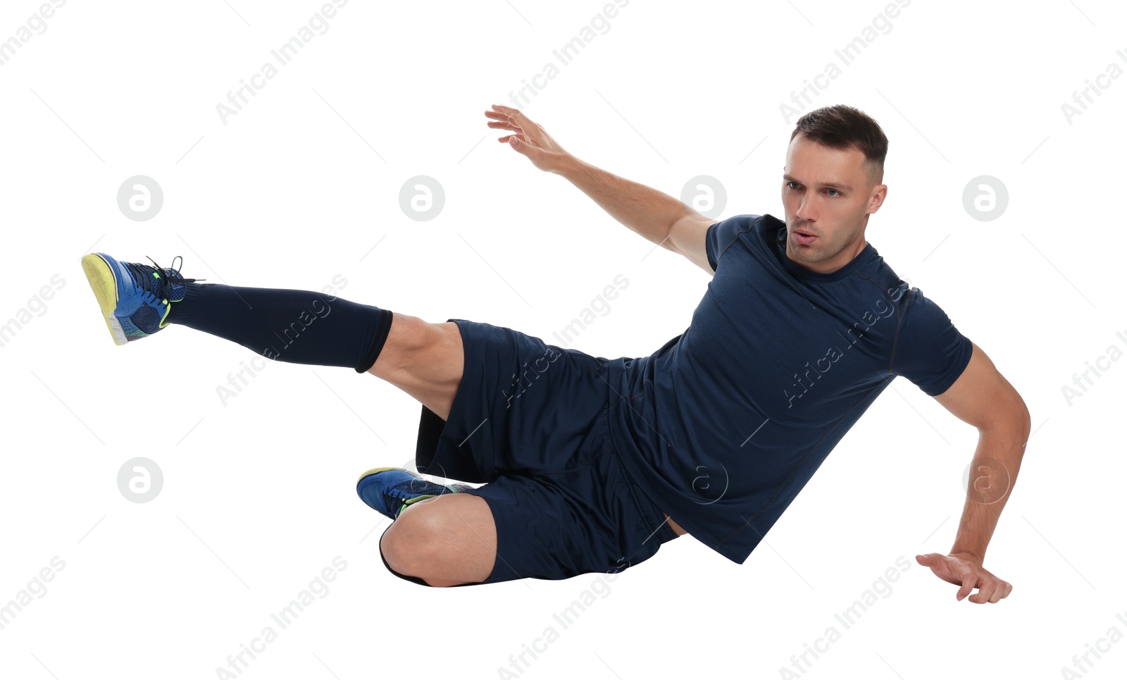 Photo of Football player in sportswear training on white background