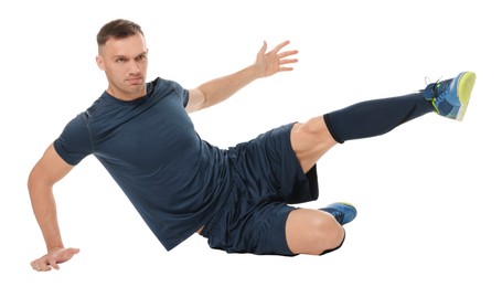 Photo of Football player in sportswear training on white background