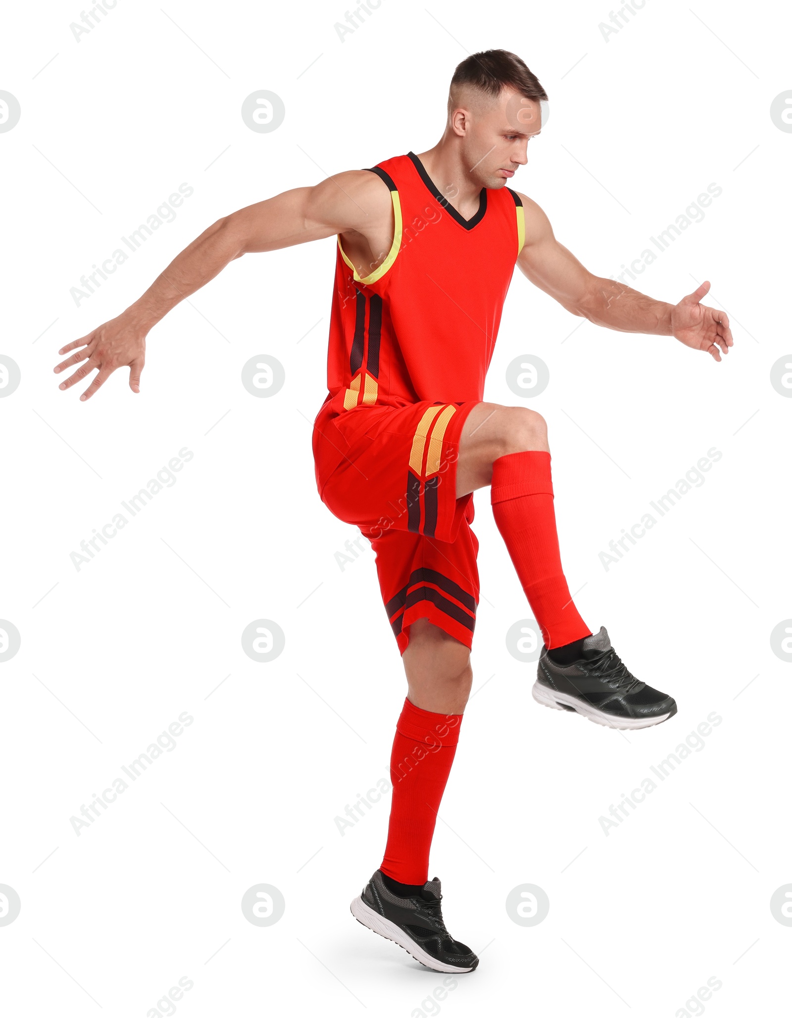 Photo of Football player in sportswear training on white background