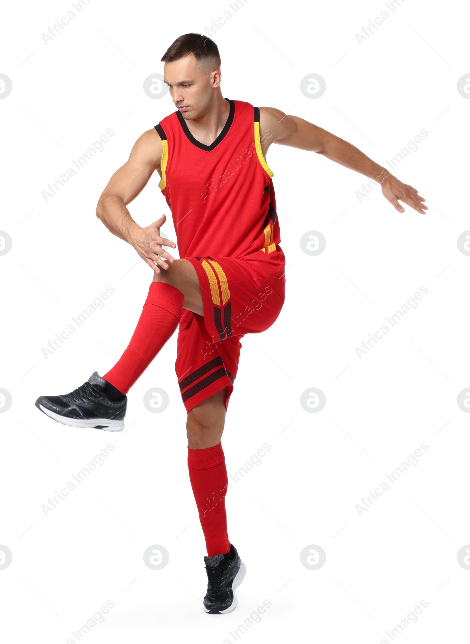 Photo of Football player in sportswear training on white background