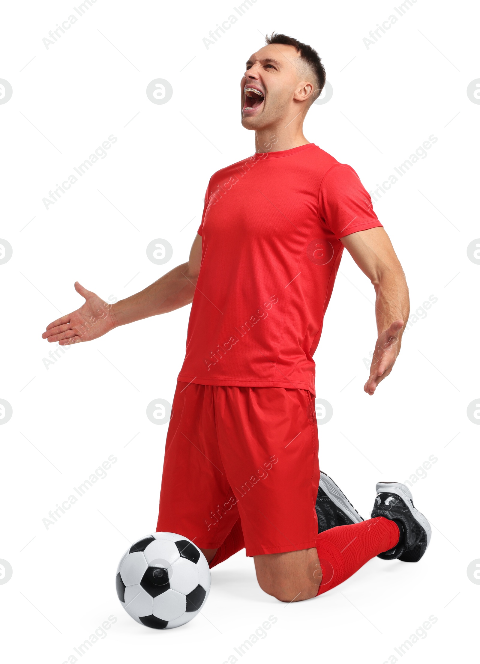 Photo of Emotional football player shouting and soccer ball on white background