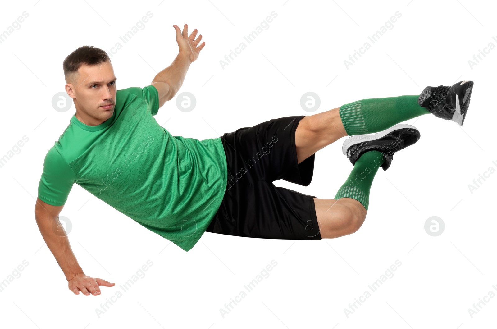 Photo of Football player in sportswear training on white background