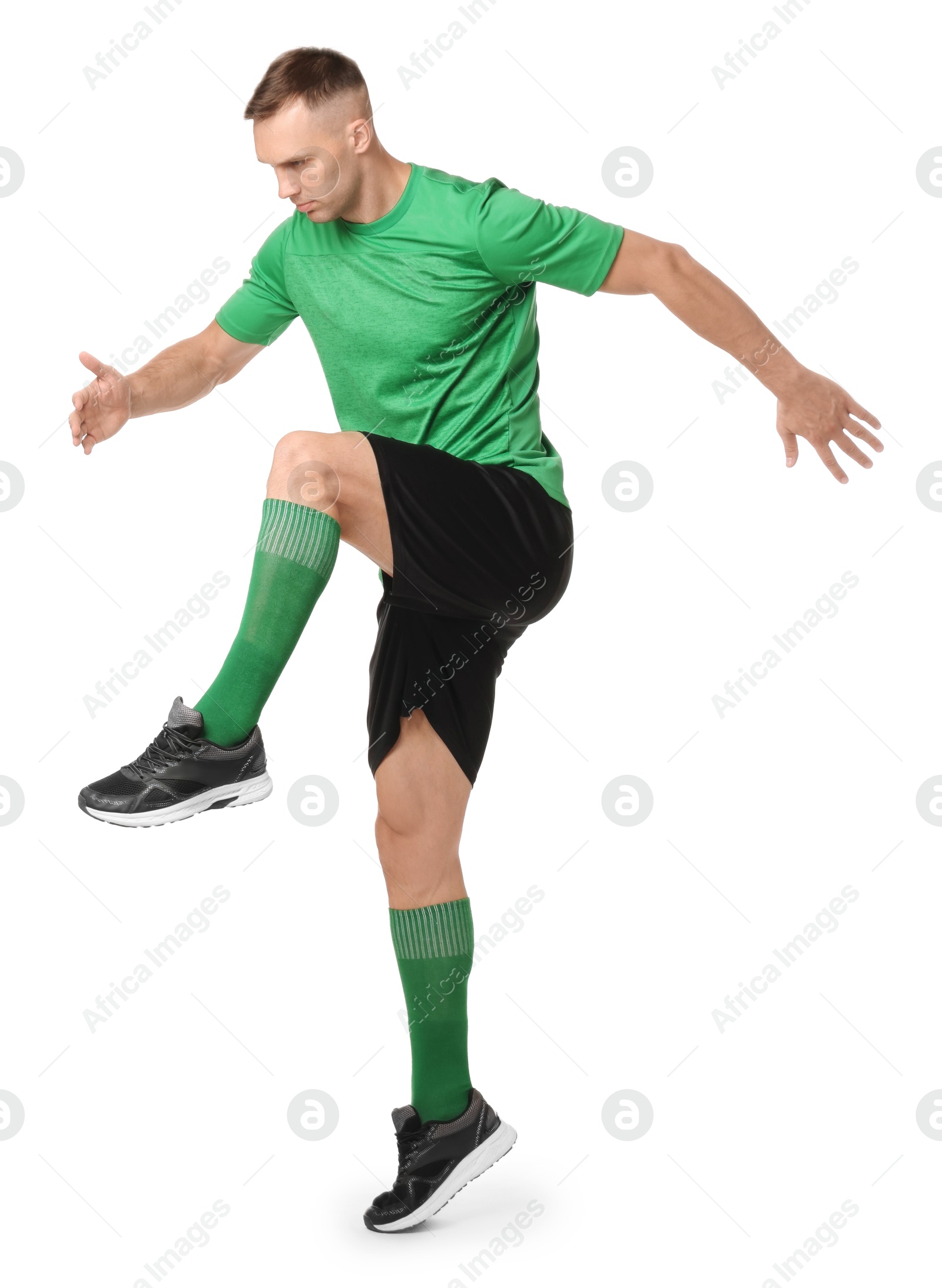 Photo of Football player in sportswear training on white background