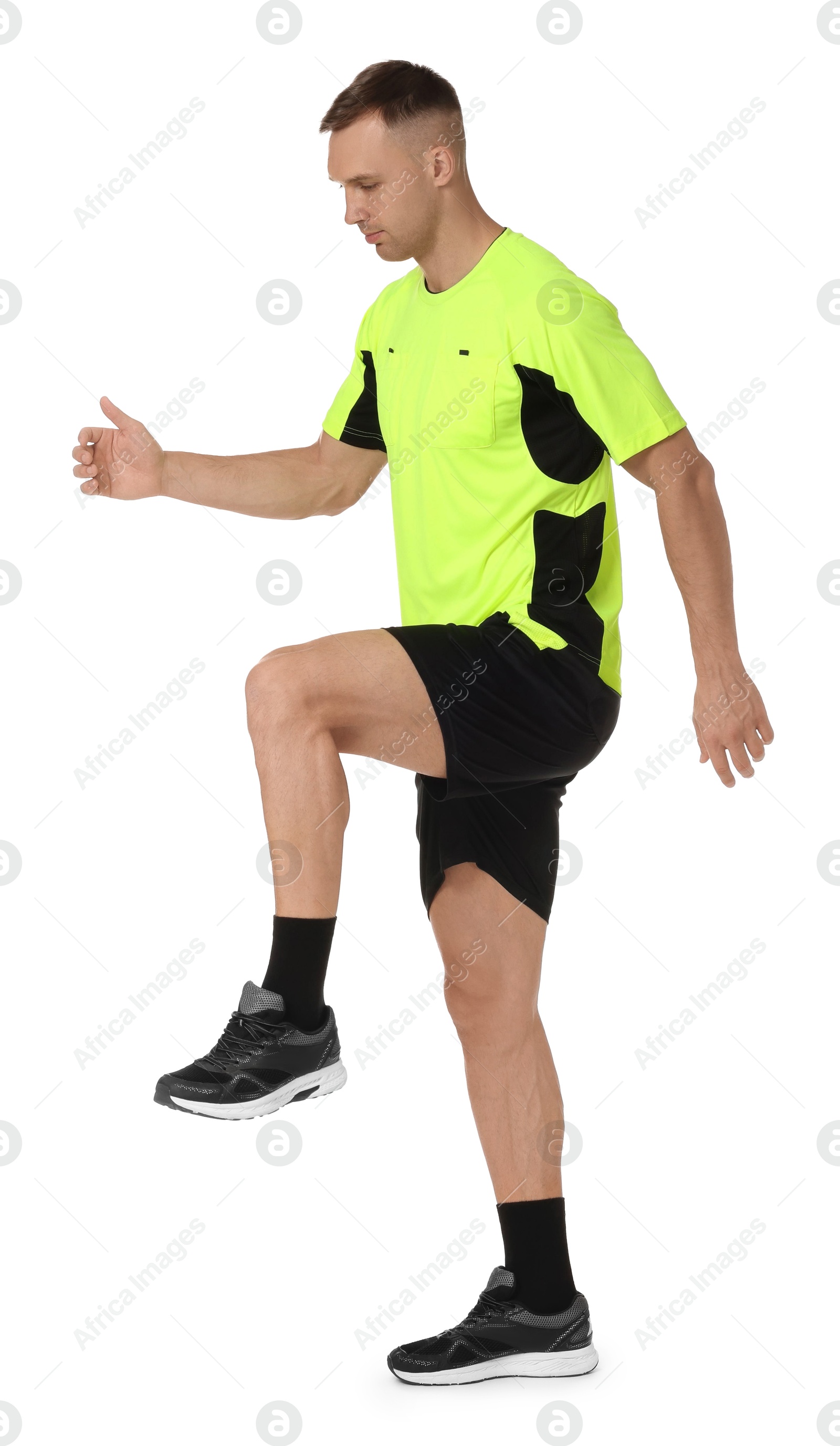 Photo of Football player in sportswear training on white background