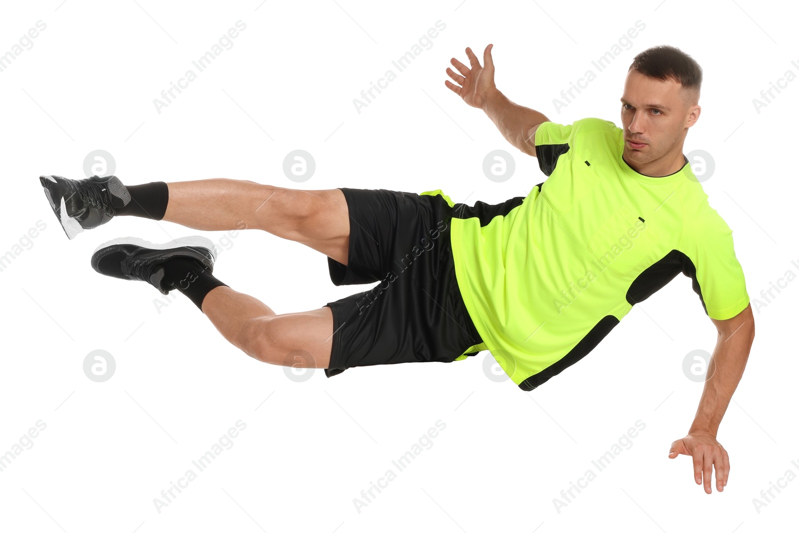 Photo of Football player in sportswear training on white background