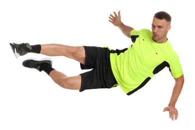 Photo of Football player in sportswear training on white background