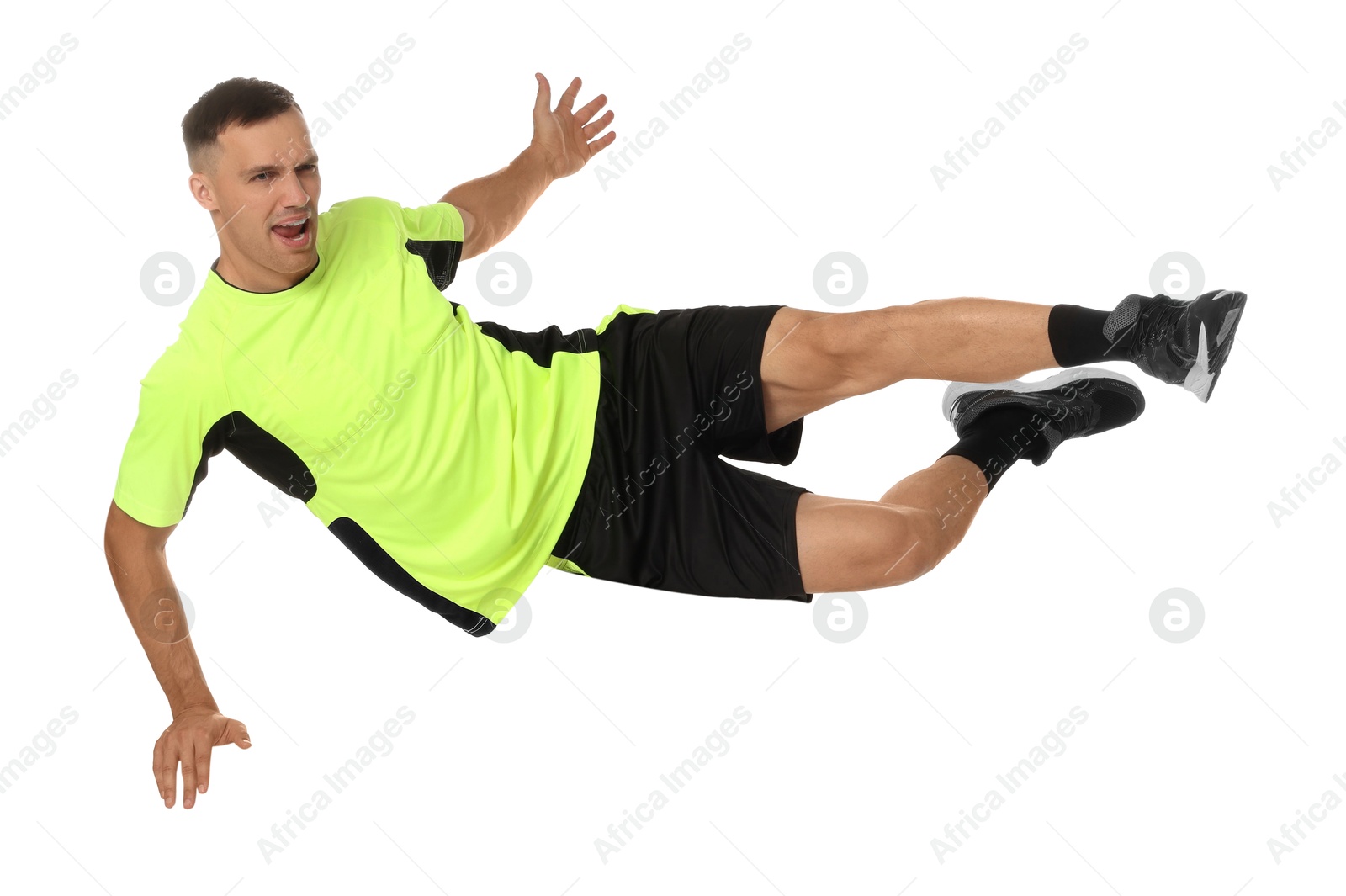 Photo of Football player in sportswear training on white background