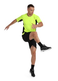 Photo of Football player in sportswear training on white background