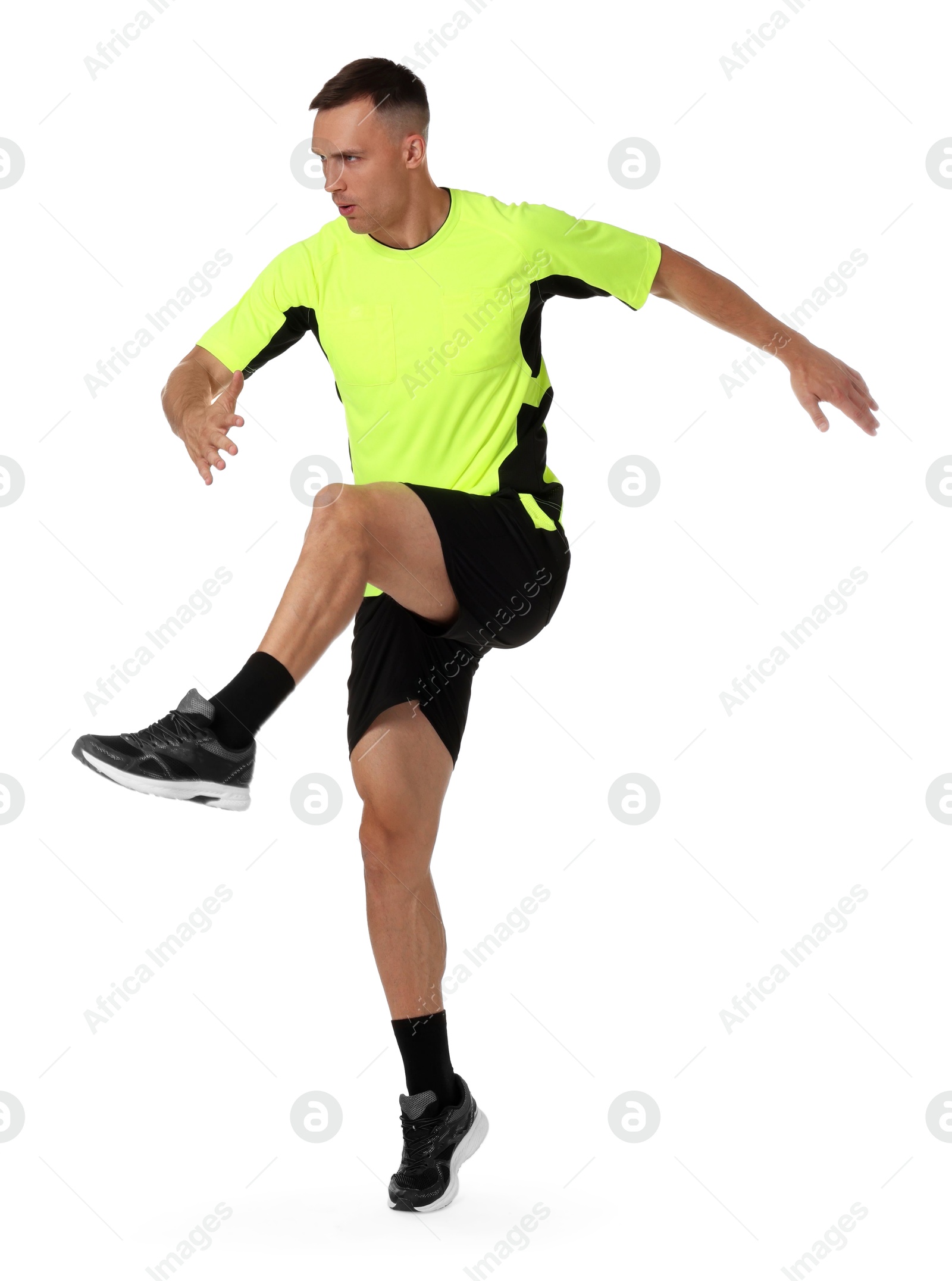 Photo of Football player in sportswear training on white background