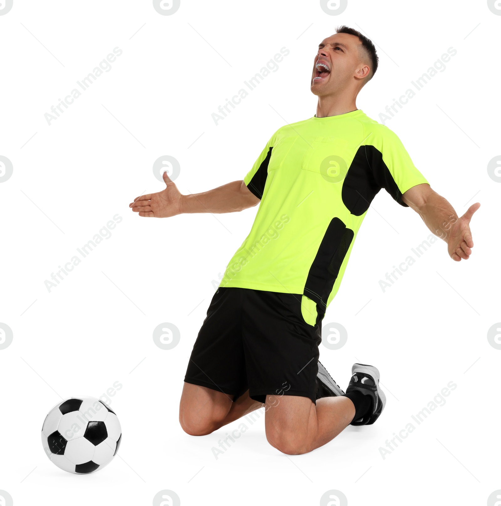 Photo of Emotional football player shouting and soccer ball on white background