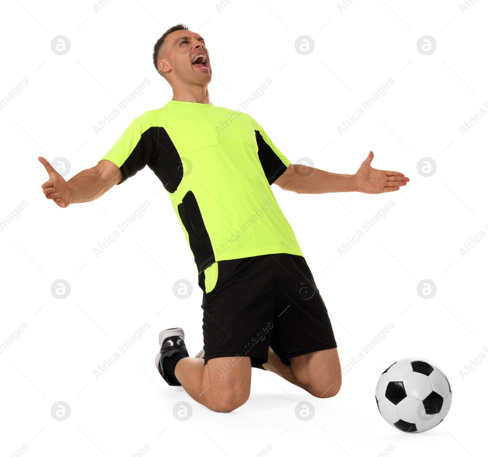 Photo of Emotional football player shouting and soccer ball on white background