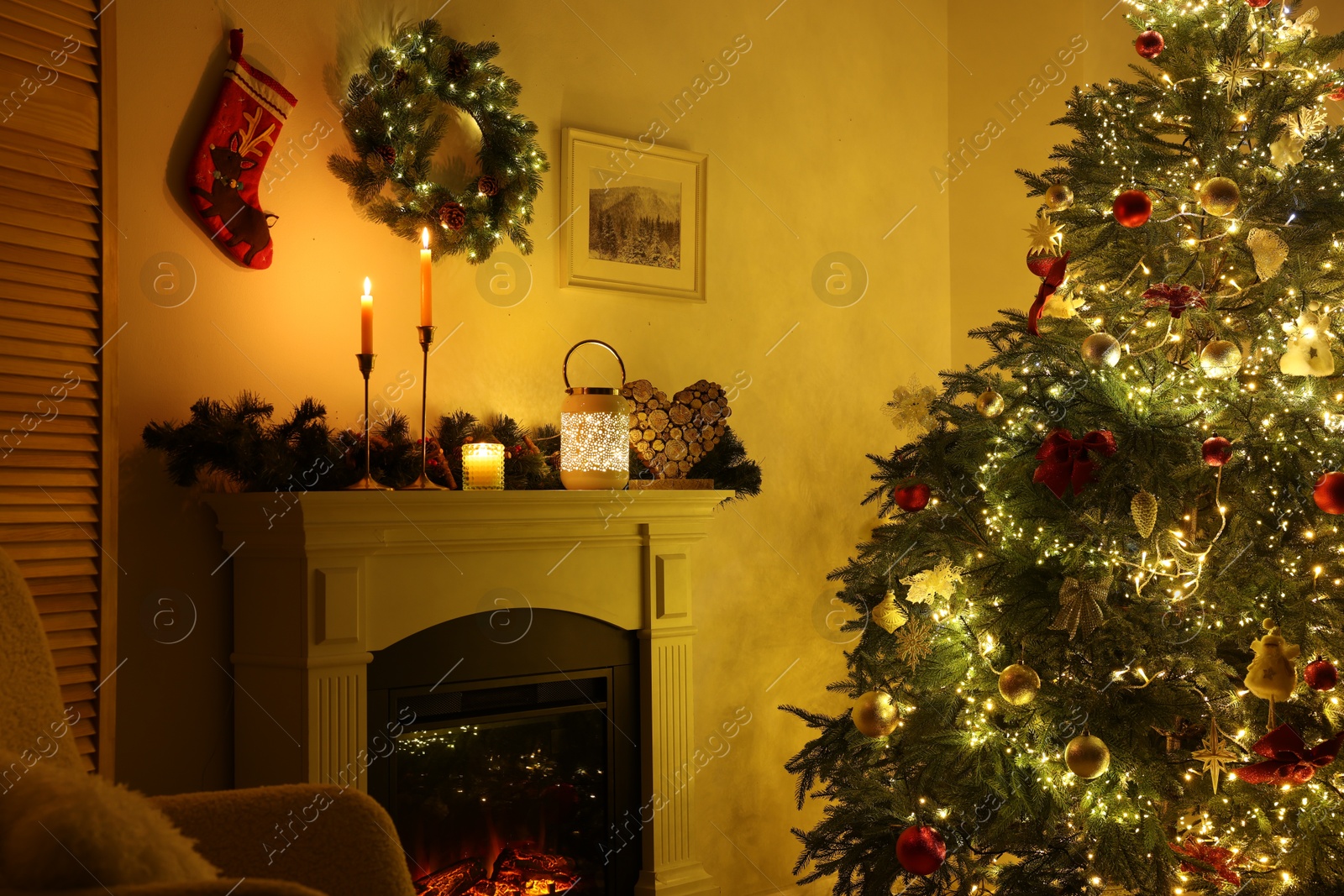 Photo of Decorated Christmas tree near fireplace in room. Festive interior design