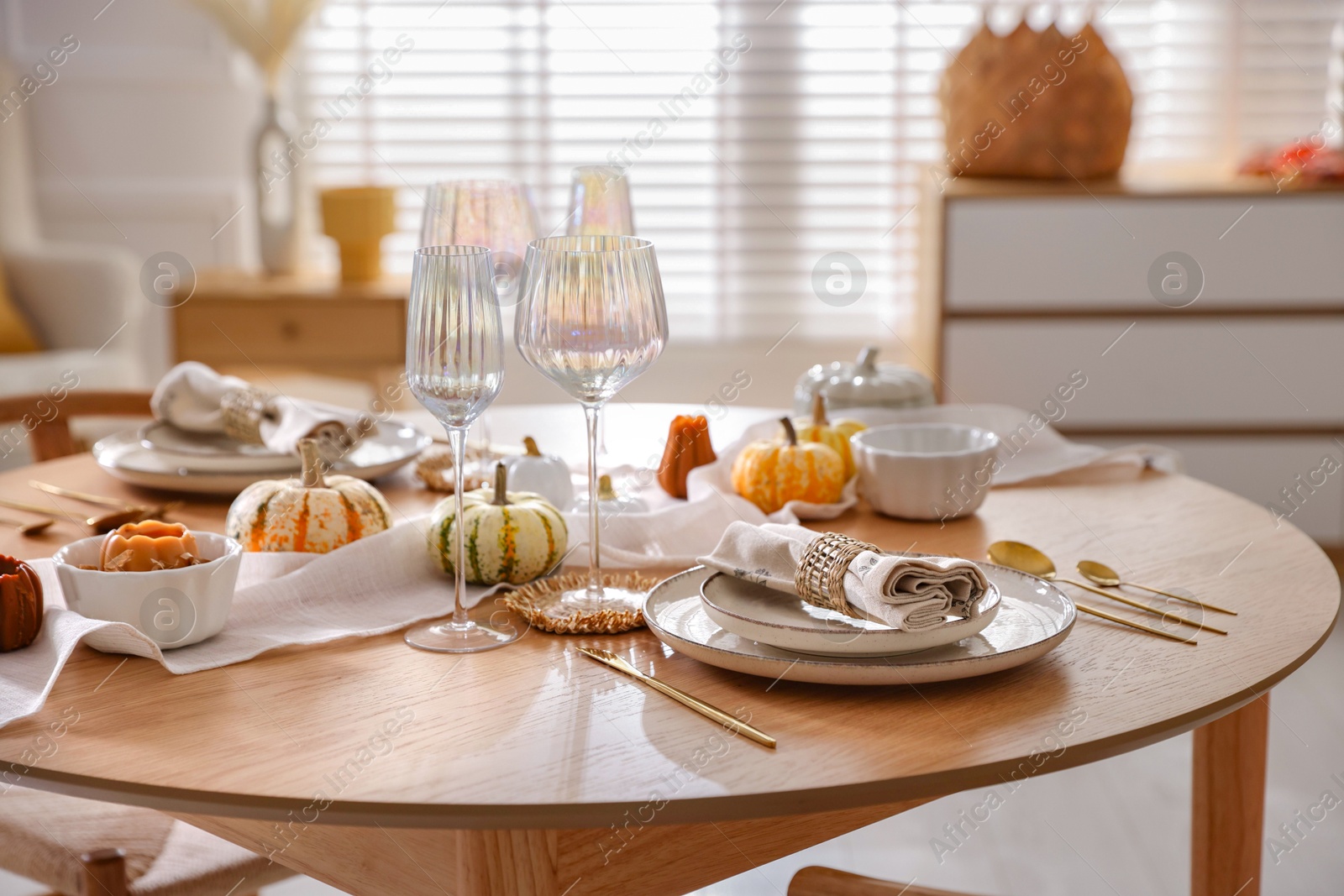 Photo of Stylish table setting with beautiful dishware and autumn decor in dining room