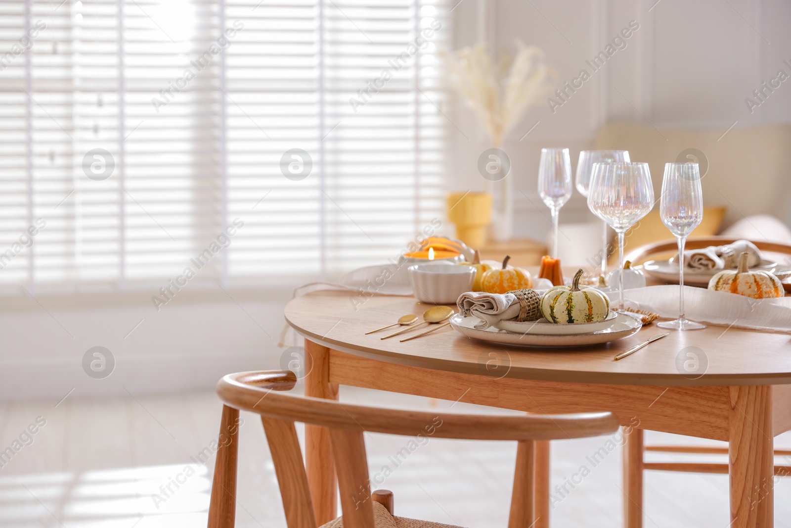 Photo of Stylish table setting with beautiful dishware and autumn decor in dining room