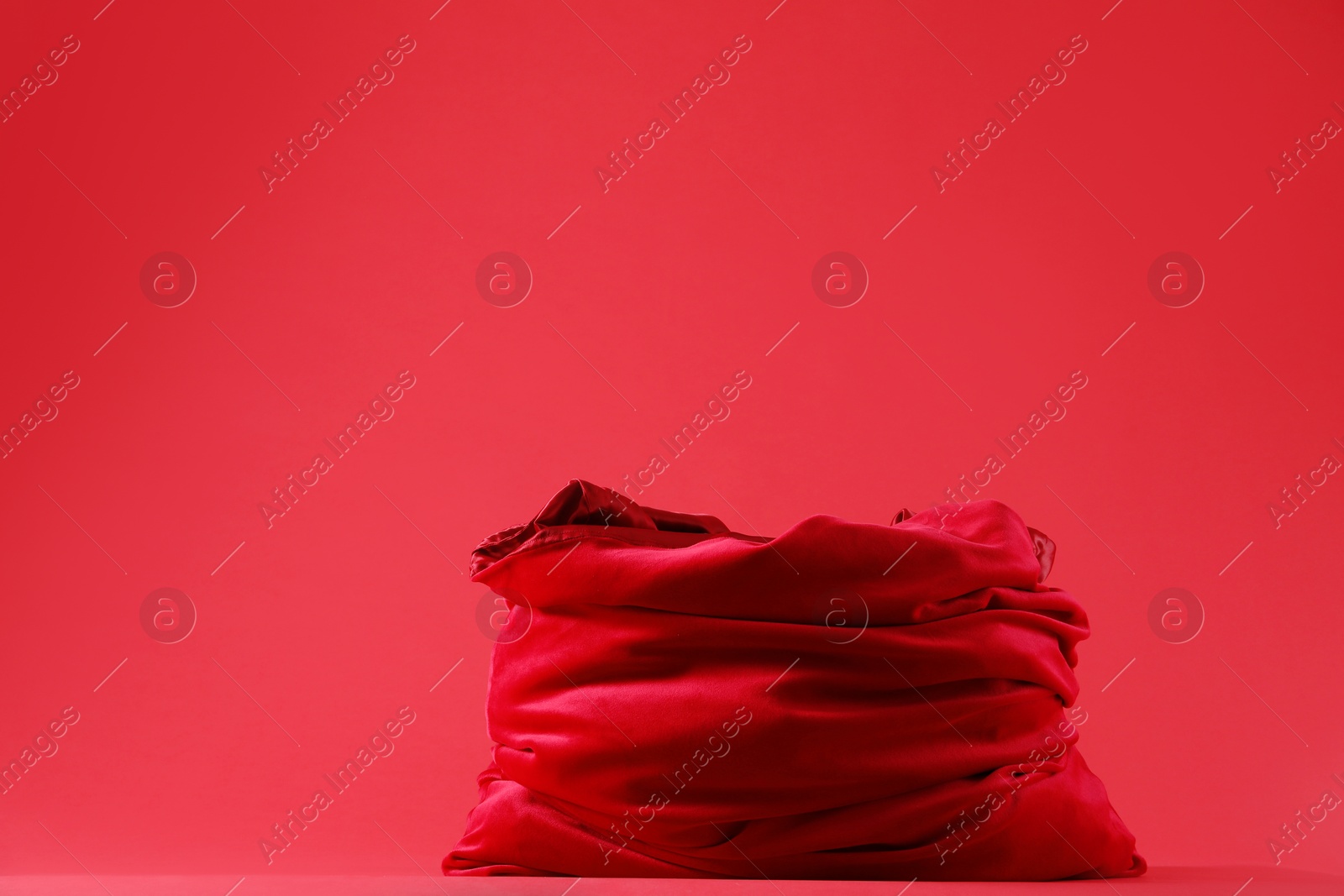 Photo of One Santa Claus bag on red background