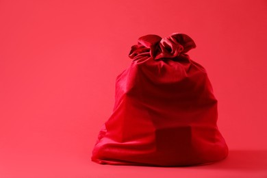 Photo of One Santa Claus bag on red background, space for text