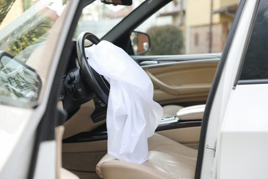 Photo of Opened airbag in automobile. Car safety equipment