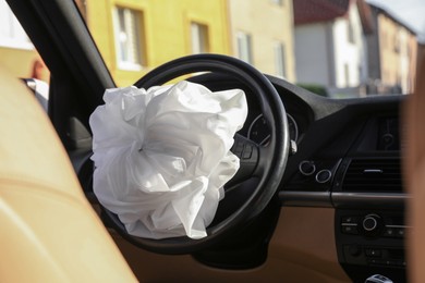 Photo of Opened airbag in automobile. Car safety equipment