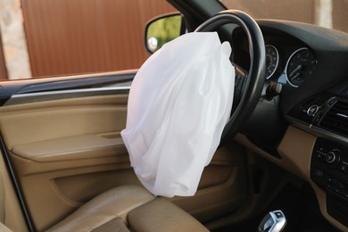 Photo of Opened airbag in automobile. Car safety equipment