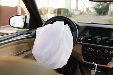 Photo of Opened airbag in automobile. Car safety equipment