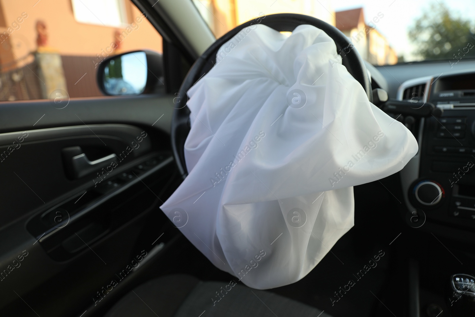 Photo of Opened airbag in automobile, closeup. Car safety equipment