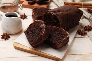 Photo of Delicious chocolate sponge cake on white wooden table, closeup