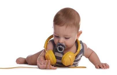 Cute little baby with pacifier and headphones on white background