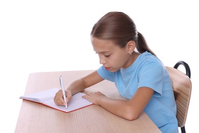 Photo of Girl with incorrect posture and notebook sitting at wooden desk on white background